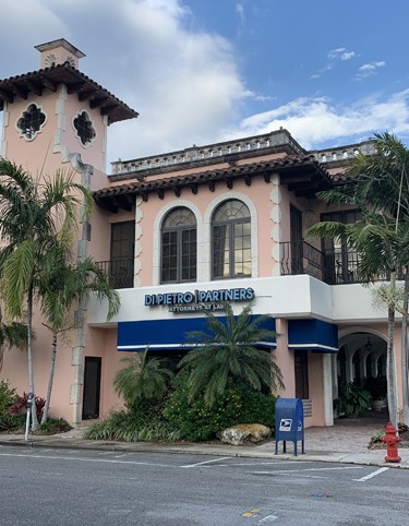 The front entrance of a law firm in Fort Lauderdale, Florida with a blue sign that reads Di Pietro Partners attorneys at law.