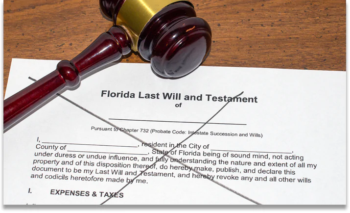 Physical copy of a Florida Last Will and Testament that's crossed off in black marker to symbolize dying without a will which leads to intestate succession