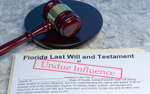Paper document titled Florida Last Will and Testament with the words undue influence stamped on it in red letters