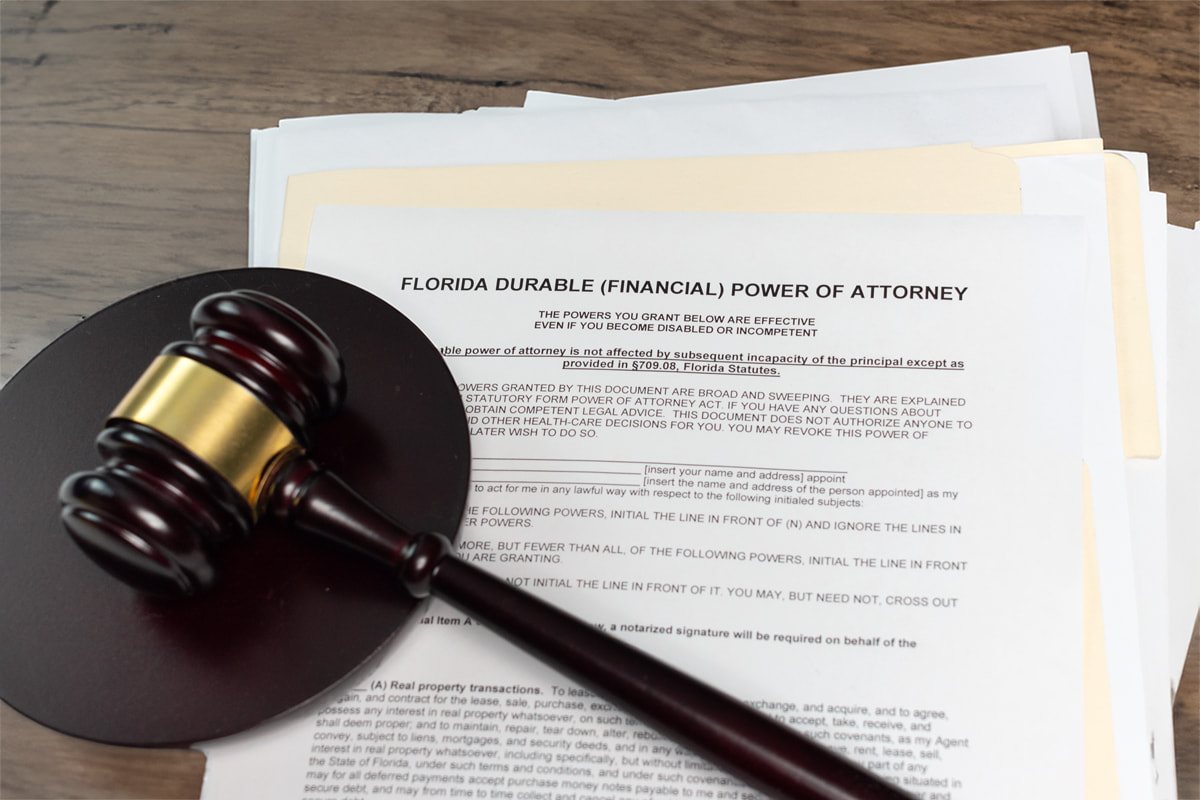 A gavel next to a Florida durable power of attorney form symbolizing power of attorney abuse and lawsuits