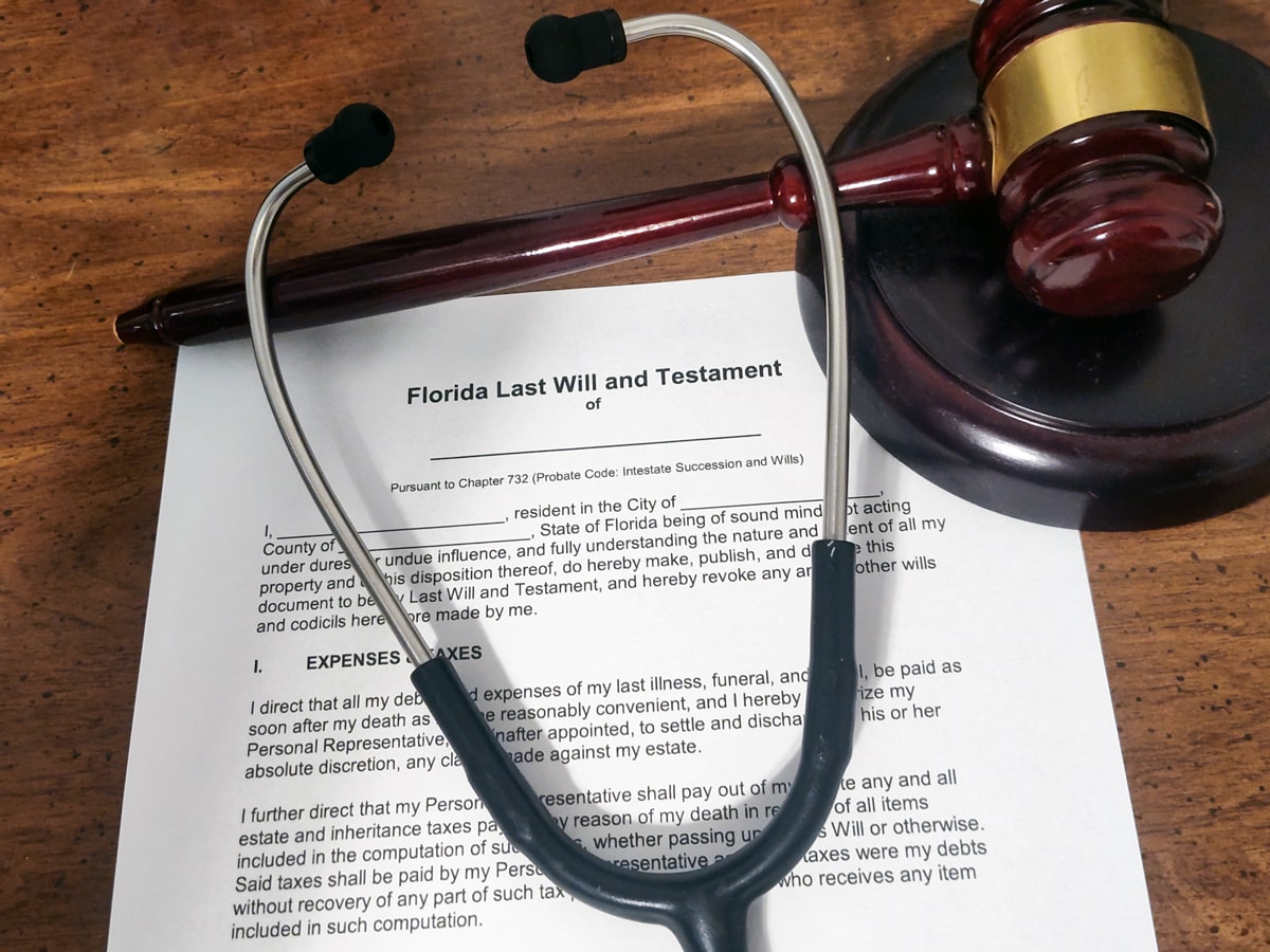 Stethoscope and judge’s gavel resting on a Florida Last Will and Testament document, symbolizing estate planning for healthcare professionals.
