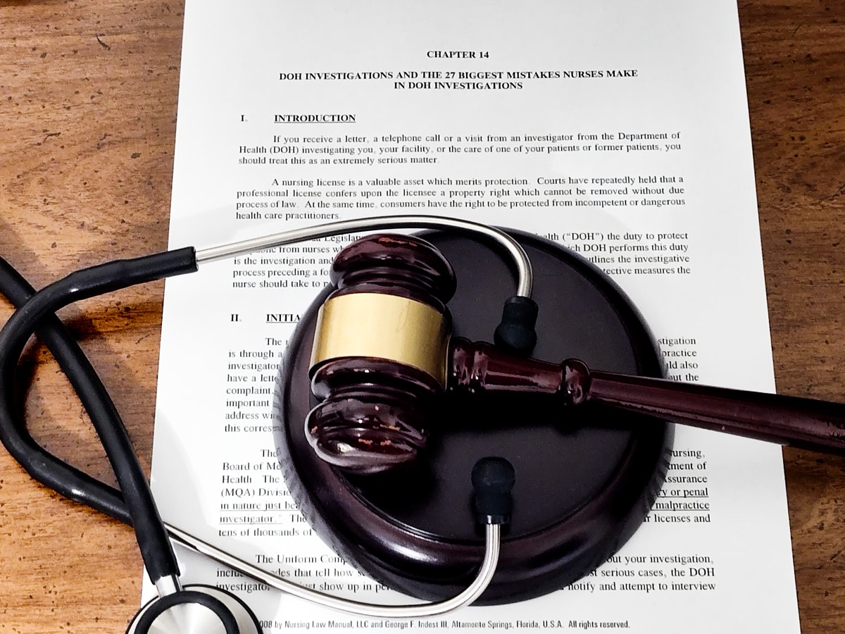 Stethoscope and gavel over document outlining Florida DOH investigation process